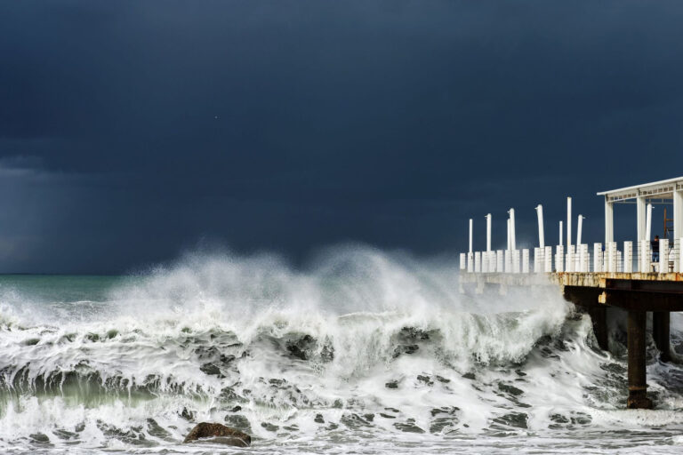 115768858 - stormy sea, waves are crashing on the pier